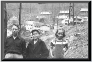 A black and white photo of three children
