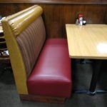 A booth with two chairs and a table
