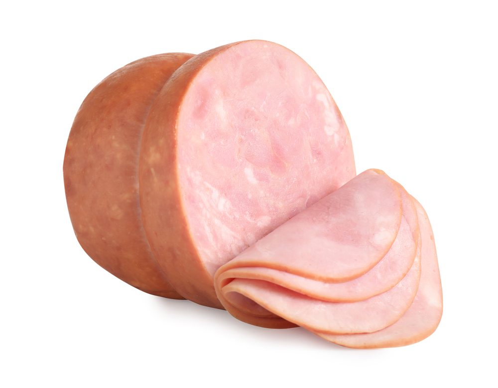 A close up of sliced ham on top of a white surface
