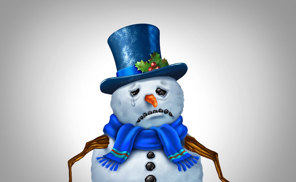 Holiday Depression And Stress as as a snowman representing the psychological issue of feeling blue during the winter season as a SAD or Seasonal Affective Disorder during the New Year.
