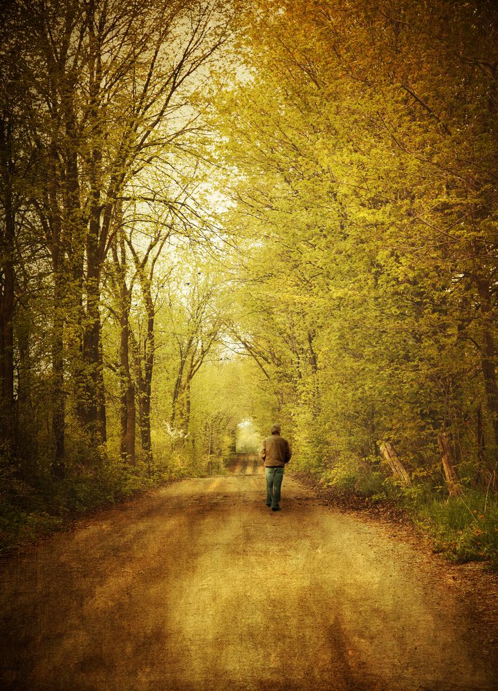 Man walking alone on a lonely country road