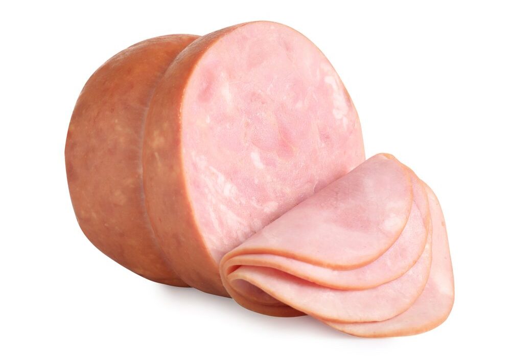 A close up of sliced ham on top of a white surface