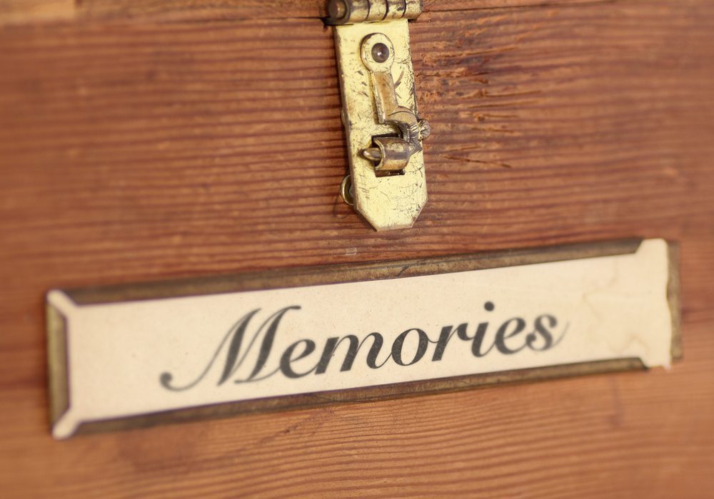 A wooden chest with the word " memories " written on it.