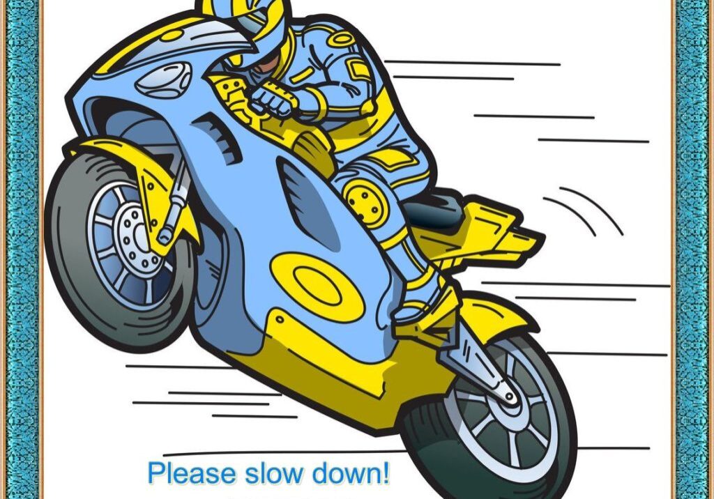 A man on a motorcycle is riding fast.