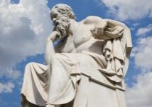 A statue of socrates is shown in front of the sky.